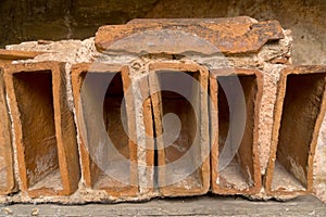 Closeup ancient Roman clay brick depressions cement
