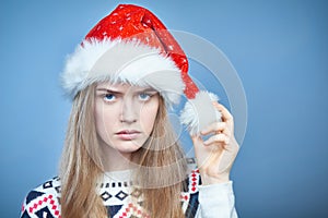 Closeup of Angry frowning woman wearing Santa hat