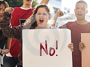 Closeup of angry teen girl protesting demonstration holding posters antiwar justice peace concept