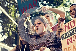 Closeup of angry teen girl protesting demonstration holding post