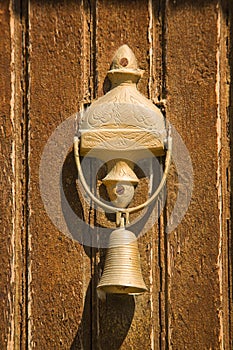 Closeup of antique bell on door