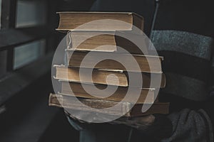 closeup of antique torn books with a hands