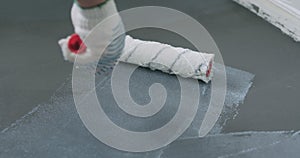 Closeup applying protective coating on the concrete floor