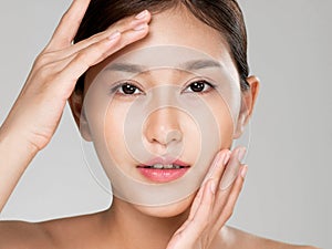 Closeup ardent young woman posing beauty gesture with clean fresh skin.