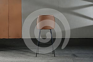 Closeup of an armless chair with a concave back, loft-style furniture