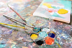 Closeup,artistic tools on colourful table,drawing and palette, paintbrush to painting watercolor on canvas,learning,activity and