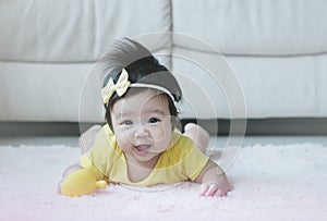 Closeup asian baby girl lie on carpet  in cute motion