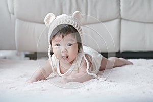 Closeup asian baby girl lie on carpet  in cute motion