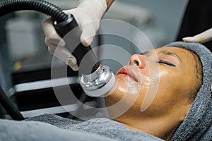 Closeup Asian beauty woman having therapy to stimulate facial skin and facial ultrasonic skincare treatment