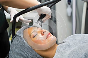 Closeup Asian beauty woman having therapy to stimulate facial skin and facial ultrasonic skincare treatment