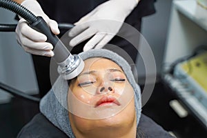 Closeup Asian beauty woman having therapy to stimulate facial skin and facial ultrasonic skincare treatment