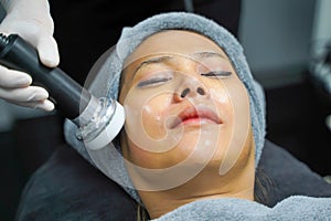 Closeup Asian beauty woman having therapy to stimulate facial skin and facial ultrasonic skincare treatment