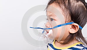 Closeup Asian face, Little baby girl sick her using steam inhaler nebulizer mask inhalation oneself