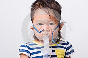 Closeup Asian face, Little baby girl sick her using steam inhaler nebulizer mask inhalation oneself