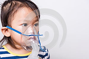 Closeup Asian face, Little baby girl sick her using steam inhaler nebulizer mask inhalation oneself