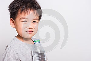 Closeup Asian face, Little children boy drinking water from Plastic bottle