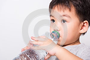 Closeup Asian face, Little children boy drinking water from Plastic bottle