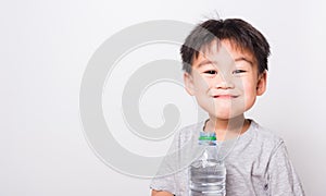 Closeup Asian face, Little children boy drinking water from Plastic bottle