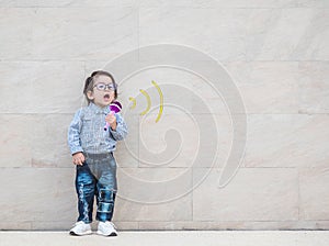 Closeup asian kid with cute medical icon on marble wall textured background in a kid want to be a doctor in a future concept with