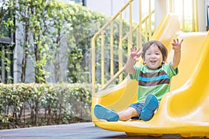 Closeup asian kid play a slider at the playground background