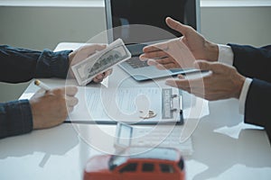 Closeup asian male people car salesman or sales manager offers to sell a car and explains and reads the terms of signing a car