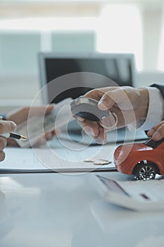 Closeup asian male people car salesman or sales manager offers to sell a car and explains and reads the terms of signing a car