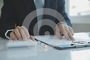 Closeup asian male people car salesman or sales manager offers to sell a car and explains and reads the terms of signing a car