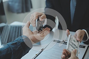 Closeup asian male people car salesman or sales manager offers to sell a car and explains and reads the terms of signing a car