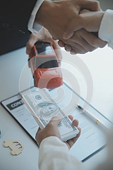 Closeup asian male people car salesman or sales manager offers to sell a car and explains and reads the terms of signing a car