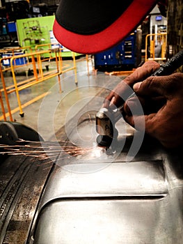 Closeup asian technician man manual grinding at surface of mold