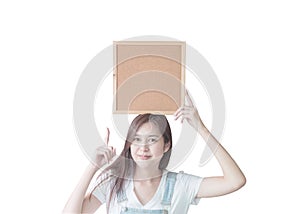 Closeup asian woman with cork board in hand and point to space in cork board isolated on white background with clipping path