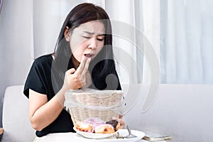 Asian woman displaying troubling behavior associated with anorexia forces herself to vomit