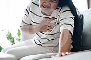 Closeup of asian woman having heart attack. Woman touching breast and having chest pain. Healthcare And Medical concept