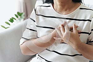 Closeup of asian woman having heart attack. Woman touching breast and having chest pain. Healthcare And Medical concept