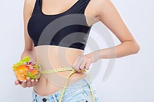 Closeup asian woman holding salad vegetable food and measuring waist for weight isolated on white background