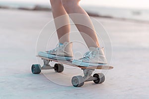 Closeup Asian woman playing on surfskate or skate board in outdoor Park