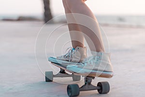Closeup Asian woman playing on surfskate or skate board in outdoor Park