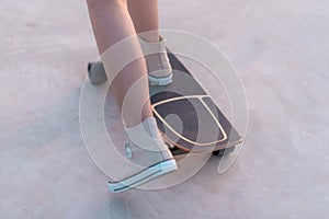 Closeup Asian woman playing on surfskate or skate board in outdoor Park