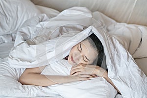 Closeup asian woman sleep on bed under blanket in bedroom background in the morning