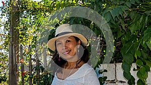 Closeup of Asian woman in white t-shirt and wearing hat in Athens photo