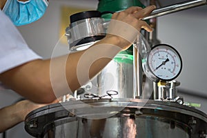 Closeup Asian worker working with ferment machine