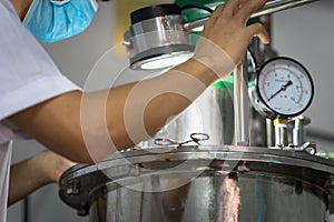 Closeup Asian worker working with ferment machine