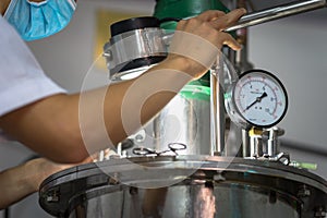 Closeup Asian worker working with ferment machine photo