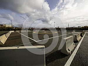 A closeup of an asphalt-covered helipad with a special symbol in the center for helicopter landing, against the backdrop of a