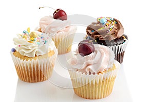 closeup of assorted buttercream cupcakes