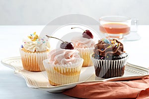 closeup assorted cupcakes with sprinkles on a plate