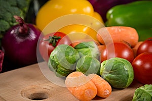 Closeup of assorted fresh vegetales on cutting board photo