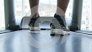 Closeup of athlete`s feet running on treadmill