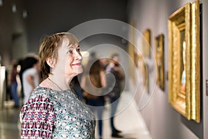 Closeup on attentive senior woman visiting museum and enjoying a