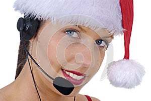 Closeup of attractive female call center telephonist wearing Christmas Santa hat